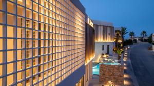an exterior view of a building with lights on at Scala Boutique Hotel & Suites - Adults Only in Agia Pelagia