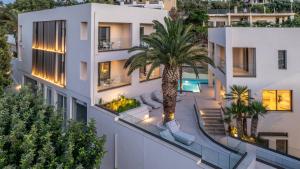 an aerial view of a building with a palm tree at Scala Boutique Hotel & Suites - Adults Only in Agia Pelagia