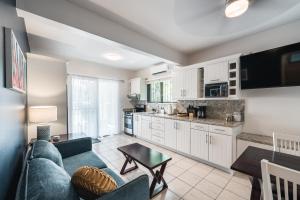 a living room with a couch and a table at Coco Garden Suites in Coco