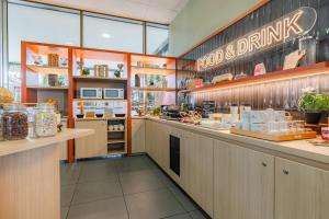 a restaurant with a counter with food and drinks at Appart'City Confort Mulhouse in Mulhouse