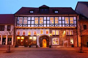 a large building with lights on the front of it at Brauhaus Zum Löwen in Mühlhausen