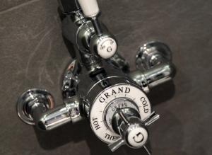 a close up of a manual valve on aaucet at The Penny Farthing Hotel in Berkhamsted