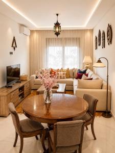 a living room with a table and a couch at Azra Mila Appart luxe famille uniquement in Saïdia +2 photos
