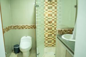 a bathroom with a toilet and a sink at La Malena, Casa Hotel in Valledupar +15 photos