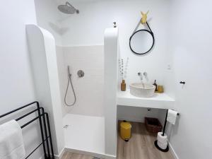 a white bathroom with a sink and a shower at Casa da Maria in Évora +47 photos