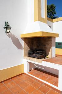 a brick fireplace on the side of a house at Casa da Barragem - Castelo de Bode in Castelo do Bode