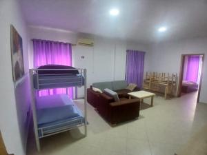 a living room with a bunk bed and a couch at Rana E Hedhun Llugani Apartments in Lezhë
