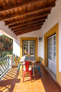 a patio with a table and chairs on a balcony at Casa da Barragem - Castelo de Bode in Castelo do Bode