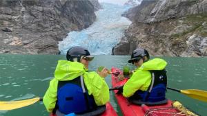 two people are in a kayak in a canyon at Monte Balmaceda Lodge & Glaciers in Torres del Paine +41 photos