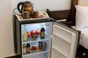 an open refrigerator with food and drinks in a room at khofo pyramids view in Cairo