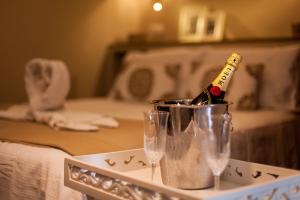 a tray with two wine glasses and a bottle of champagne at Hostal Boutique Plaza Cantarero in Nerja