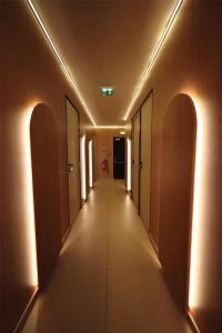 a hallway with arches and a long corridor at Best Western Plus Le Picardy Hotel & Spa in Saint-Quentin