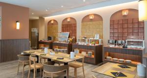 a restaurant with tables and chairs and a bakery at Modica Inn Centro, BW Premier Collection in Modica