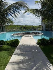 a large swimming pool with chairs in a building at Gav Resorts in Ipojuca +2 photos