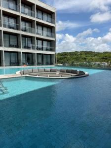 a swimming pool in front of a large building at Gav Resorts in Ipojuca