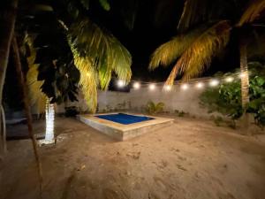 a swimming pool in a backyard at night at Precioso chalet en Telchac Puerto in Telchac Puerto