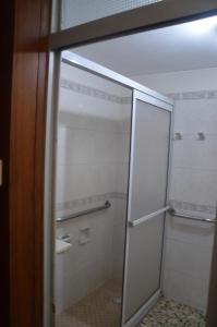a shower with a glass door in a bathroom at Habitación Privada "SUR" con baño privado, dentro de una casa compartida estilo Hostel 3B in Salto +7 photos