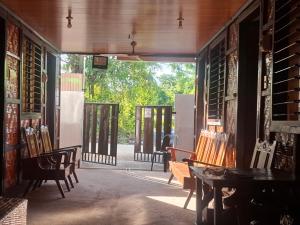 an open door to a room with chairs and tables at Shiloh Homestay in General Luna