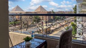 a balcony with a view of the pyramids at Hammis Pyramids View INN in Cairo