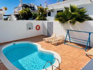 a swimming pool on the roof of a house at Sol y Mar Surf Camp in Corralejo