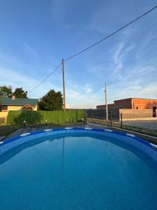 a large blue swimming pool in a yard at Kuća za odmor Štiba in Vinkovci