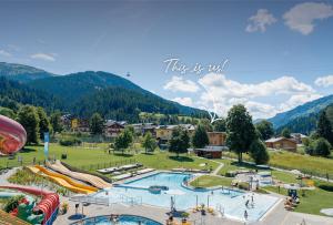 an amusement park with a water park with slides at Mariengut - Natur Aparthotel Kramer in Wagrain
