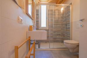a bathroom with a toilet and a glass shower at Villa Artistica in Trappola +50 photos