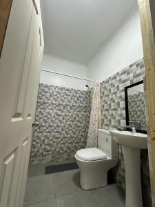 a bathroom with a toilet and a sink at Casa & Habitaciones in Mejillones +12 photos