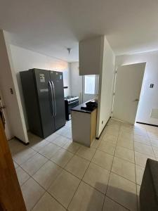 a kitchen with a stainless steel refrigerator in a room at Casa & Habitaciones in Mejillones