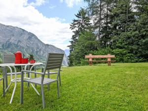 a table and chairs and a bench in the grass at Chalet Mélèze 1967 by Interhome in Ovronnaz