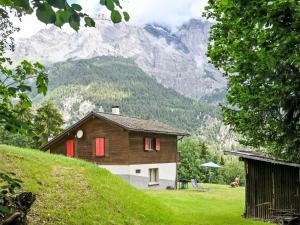 a house on a hill with mountains in the background at Chalet Mélèze 1967 by Interhome in Ovronnaz