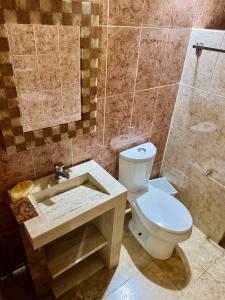a bathroom with a toilet and a sink at La Casa de las Lunas in Chichén-Itzá +32 photos
