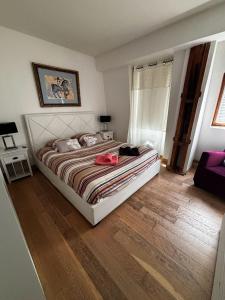 a bedroom with a bed with a red bag on it at Appartements à Deauville dans Triangle d'Or in Deauville