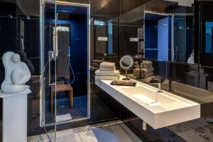 a bathroom with a sink and a mirror at Relais Villa Flora Berta in Matelica +73 photos