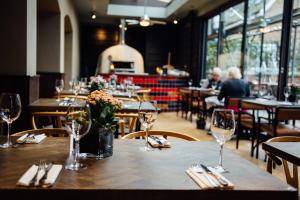 a table in a restaurant with wine glasses on it at The Penny Farthing Hotel in Berkhamsted