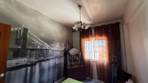 a room with a wall mural of a city at Casa Nautica in Paço de Arcos