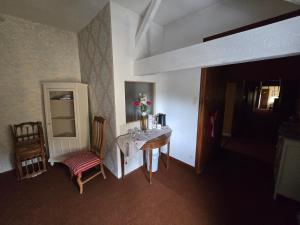 a room with a table and a chair and a mirror at Les Pierres Du Périgord 200 in Couze-et-Saint-Front +69 photos
