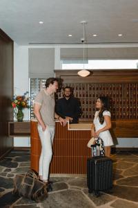 a man and a woman standing at a counter at Caravan Court Hotel in Arlington +51 photos