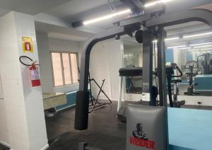 a room with a gym with a machine in it at Duomo Park Hotel in Curitiba