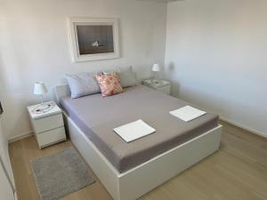 a small bedroom with a bed with two night stands at Apartment BELLA in Karlobag