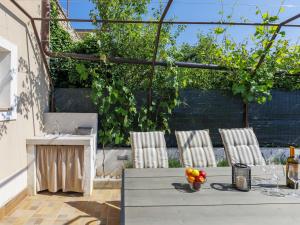 a patio with a table and chairs with fruit on it at Apartment L&V by Interhome in Galižana +28 photos