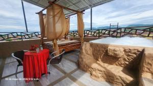 a room with two beds and a table on a balcony at PH BOUTIQUE HOTEL Girardot in Girardot