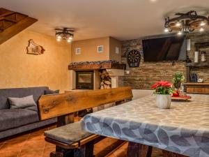 a living room with a table and a couch at Chalet Cozy Bear Cabin by Interhome in Mrkopalj
