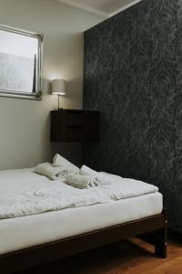 a bedroom with a bed with a mirror and a wall at Złota Brama - Old Town Apartment 1 in Gdańsk