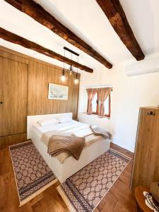 a bedroom with a large white bed in a room at Konoba Stanisic in Balabani