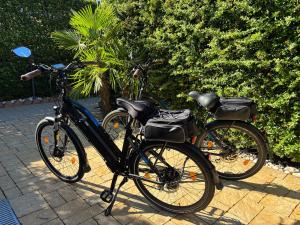 two bikes parked next to each other on a sidewalk at B&B Desenzano Paradise in Desenzano del Garda