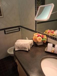 a bathroom with a sink and a mirror at Casa Ninni in Tremezzo