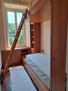 a bedroom with a bunk bed and a window at Casa Ninni in Tremezzo