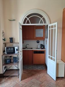 an open door to a kitchen with a microwave at Casa Ninni in Tremezzo