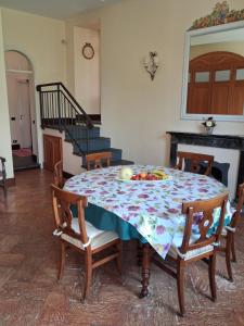 a dining room table with a flowered table cloth at Casa Ninni in Tremezzo +16 photos